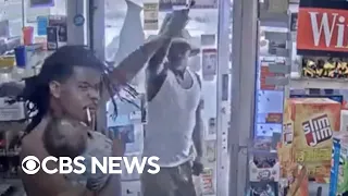 Father holding baby fends off man with gun at Detroit gas station