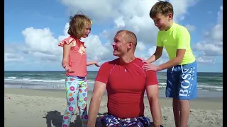 Max and Katy looking for surprise toys on the Beach with dad