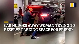 Car nudges away woman trying to reserve parking space for friend in China