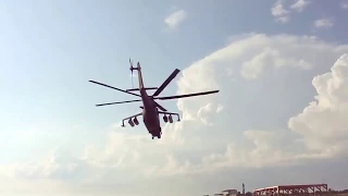 Russian military Mi-35 helicopter flying over the beach.