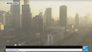 China: natural sunlight breaks through over Beijing's skyline as red alert is lifted