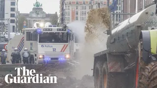 Belgian farmers spray manure towards police who respond with water cannon