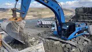 Blue Caterpillar 345C Excavator Loading Trucks