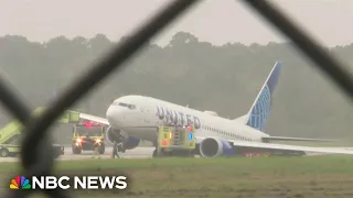 Runway shut down after United plane slides into grass