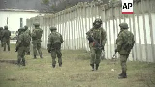 Hundreds of gunmen surround Ukraine military base, blocking soldiers from leaving