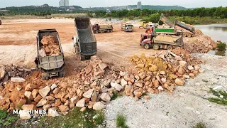 Huge Land Reclamation Process Massive Dump Truck Unloading Big Stone Bulldozer Pushing Clearing Rock