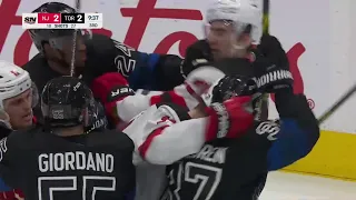 Scrum ensues between the Maple Leafs and the Devils after exchanges of hitting