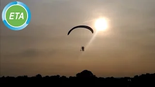 Paravelo flying bicycle landing at dusk