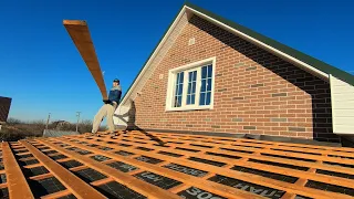 The guy is building an amazing pitched roof. Lathing for metal tiles