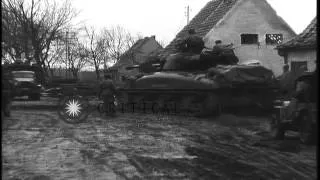 Soldiers aboard tanks cross a pontoon bridge across the Roer River and a sign boa...HD Stock Footage