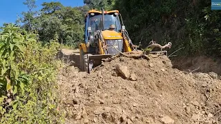 Busy Hillside Road Dirt Clearing and Filling Ruts with JCB Backhoe