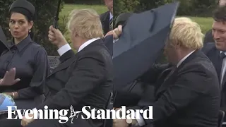 Boris Johnson had umbrella troubles again leaving Prince Charles & Priti Patel laughing