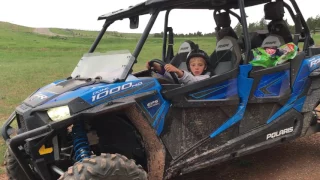 Already driving the big boys toys. 8 year old driving 1000 rzr