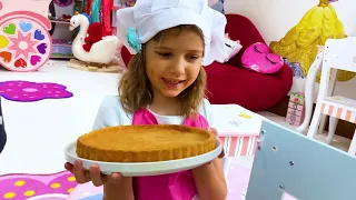 Katy and Max cooking for daddy on their drive thru cafe