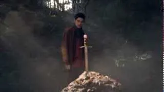 Merlin places excalibur into the stone