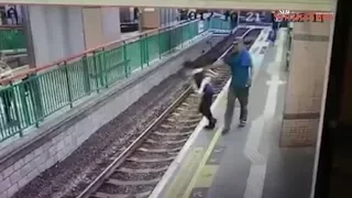 Man pushes woman onto Hong Kong rail tracks, casually walks away