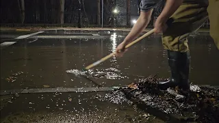 Draining A Flooded Street. Storm Drain Unclogging