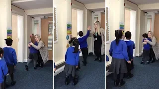 Doting Teacher's Morning Routine Offers Children Hugs and High-Fives