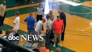 Basketball player saves referee