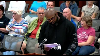 John Amanchukwu is kicked out of school board meeting by Sheriff's for reading a pornographic book