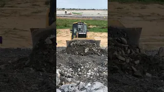 Shantui bulldozers push rock