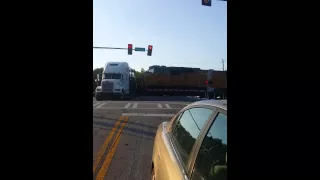 Truck get stuck on train tracks.
