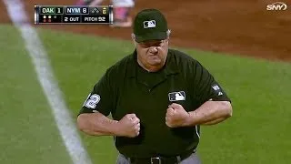 Joe West flexes after getting hit by ball