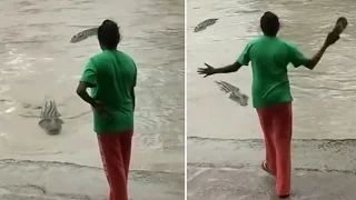 Woman shoos away a croc with just her flip-flops