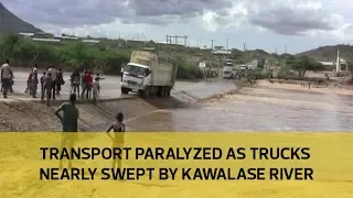 Transport paralyzed as trucks nearly swept by Kawalase river