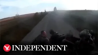 Moment armoured vehicle carrying fleeing Russian soldiers flips over on road