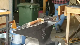 Straightening a badly warped hardened steel blade with a carbide hammer.