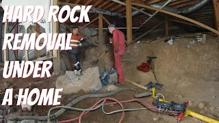 Removing hard rock from under a home