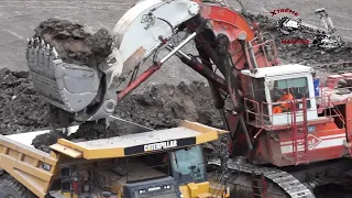 O&K RH 120C EXCAVATOR AND TRUCK AT WORK.