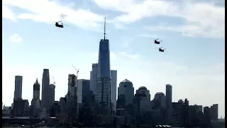 A trio of Boeing CH-47 heavy lift helicopters fly over the Hudson river across Manhattan skyline