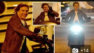 Arc De Triumph! Tom Cruise flashes a broad smile as he rides a motorbike in Paris during Mission Im