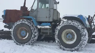 Т 150 plowing through the snow