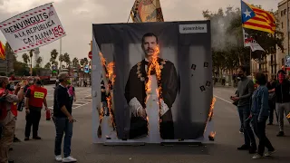 Catalans protest royal visit by burning poster of Spanish King