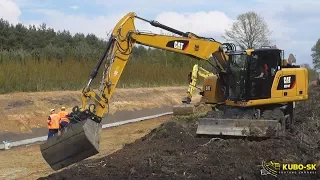 CAT M314F wheeled excavator pulling slopes