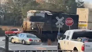 Raw video: Train crashes into car in Georgia as driver escapes just before impact.