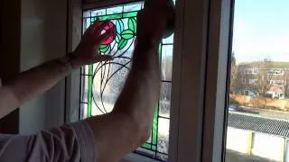 Applying Peels of London stained glass window film to your window.