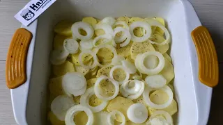 Crucian carp whole under sour cream with potatoes and onions in the oven