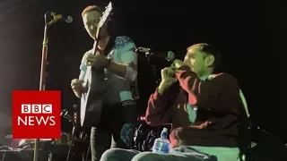 Disabled fan's on-stage performance with Coldplay - BBC News