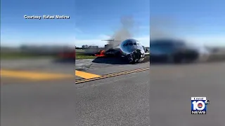 Videos show plane on fire at Miami International Airport