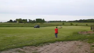 Racing Geo Tracker and Jeep Wrangler On Hay Field