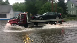 cars driving through water flooded streets