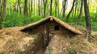 A man built a shelter in the forest and spends the night in it