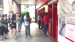 People queueing at cash deposit machines at POSB Tampines Central around 9am