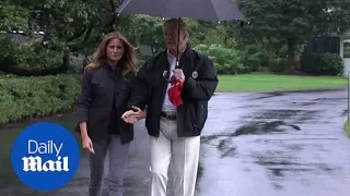 President Trump and Melania hold hands as they board Marine One