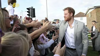 Prince Harry Kisses The Hand of a Fan