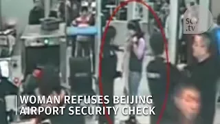 Chinese woman refuses security check at Beijing airport